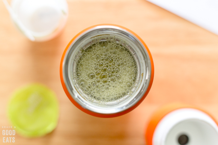 overhead view of blended green smoothie inside the Vejo