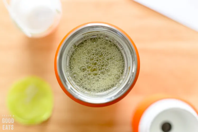 overhead view of blended green smoothie inside the Vejo