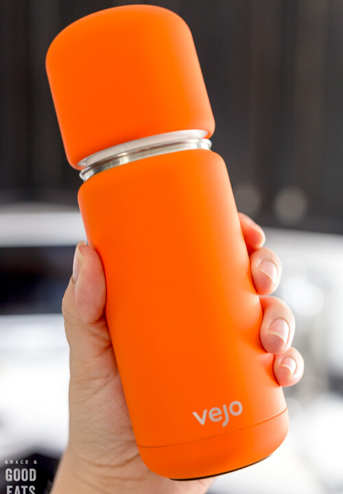 hand holding up an orange vejo blender