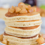 stack of pancakes topped with apple compote