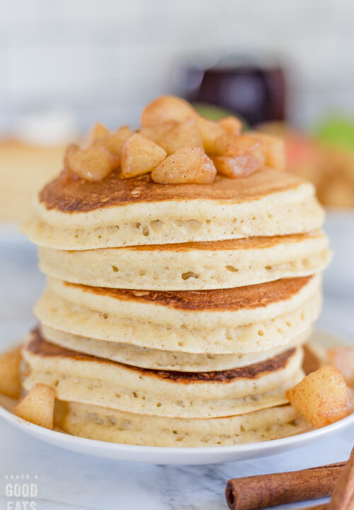 stack of pancakes topped with apple compote