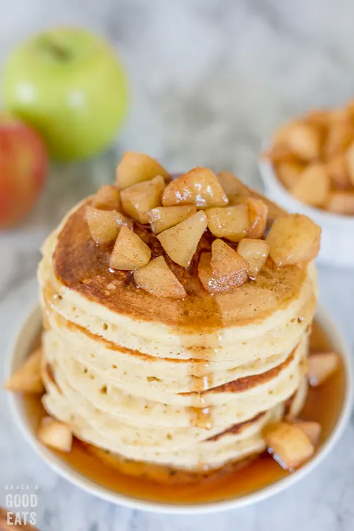 stack of pancakes with apple compote and syrup