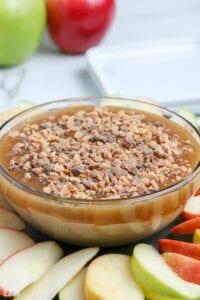 bowl of caramel sauce topped with toffee bits
