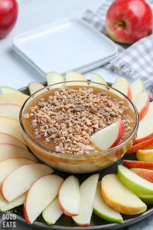 bowl of caramel sauce with apple slice in the caramel