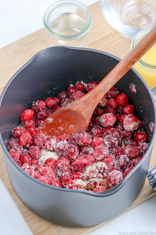 whole cranberries with sugar in a saucepan