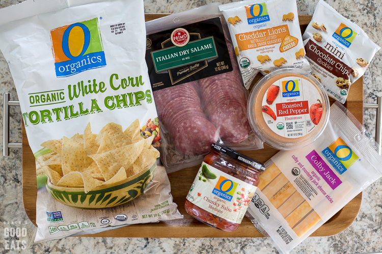 packaged snacks on a wooden tray