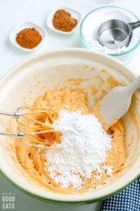 pumpkin puree, cream cheese, and powdered sugar in a bowl