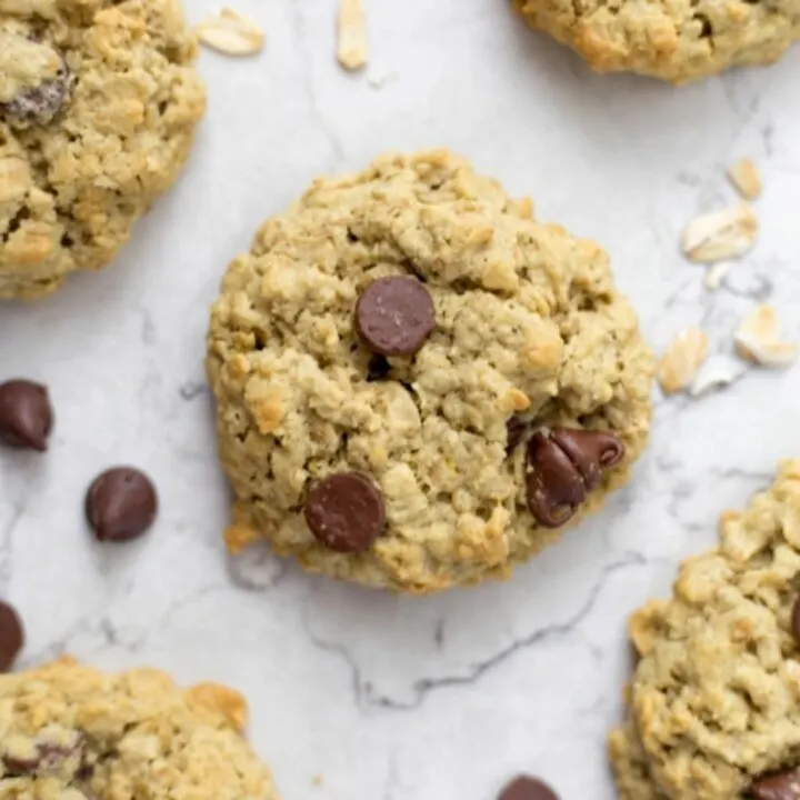 protein cookies on a countertop next to chocolate chips