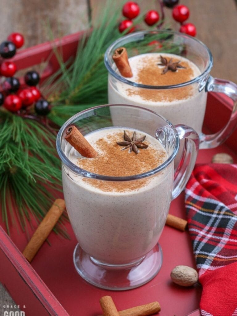 eggnog in a glass mug on a red tray