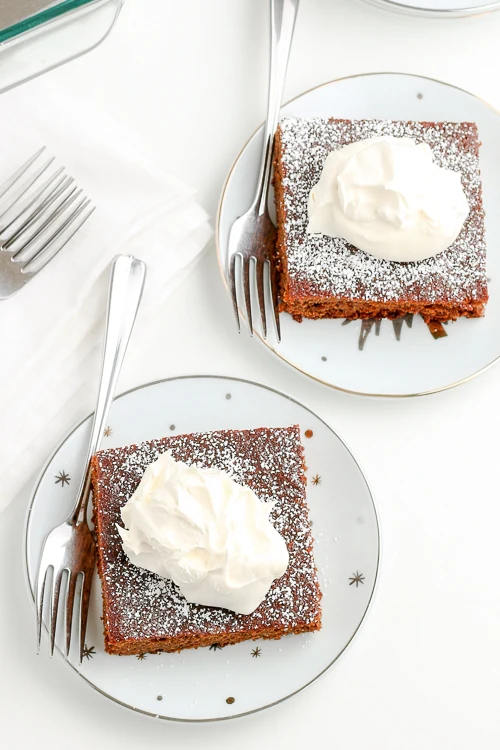gingerbread cake on white plates with silver forks