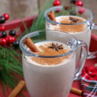 glass mug with homemade eggnog and a cinnamon stick