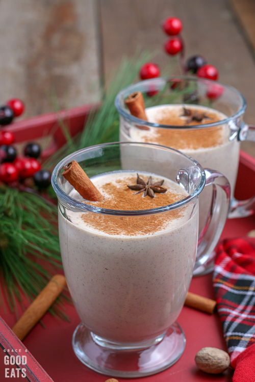 glass mug with homemade eggnog and a cinnamon stick