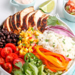 chicken burrito bowl ingredients arranged in a bowl