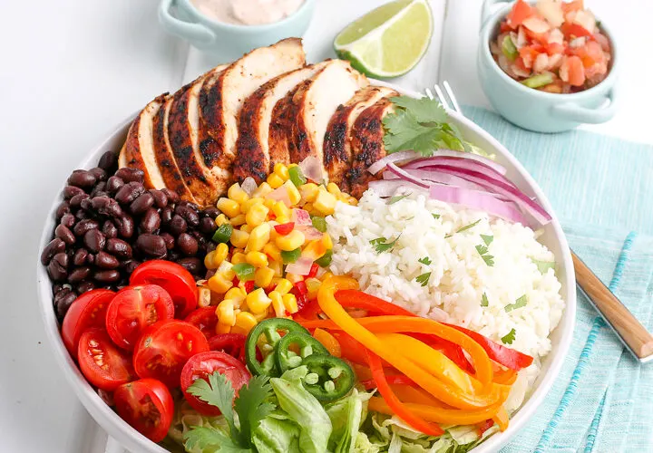 chicken burrito bowl ingredients arranged in a bowl