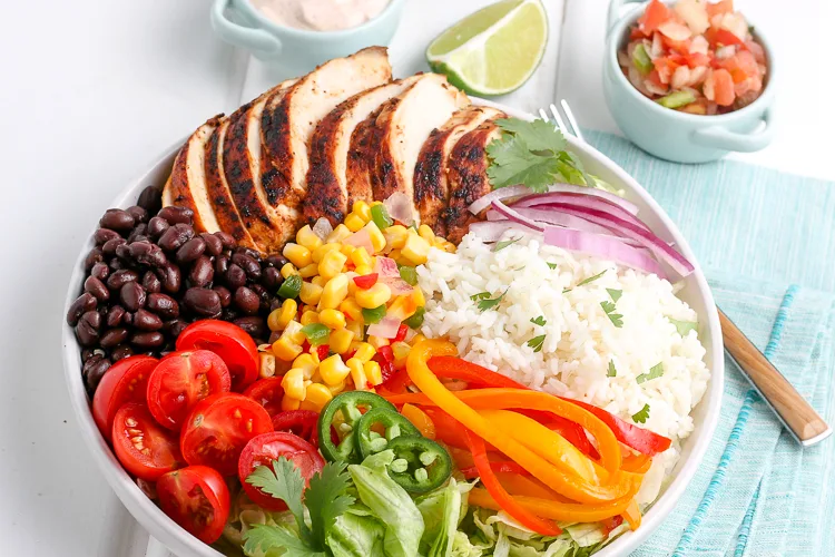 chicken burrito bowl ingredients arranged in a bowl