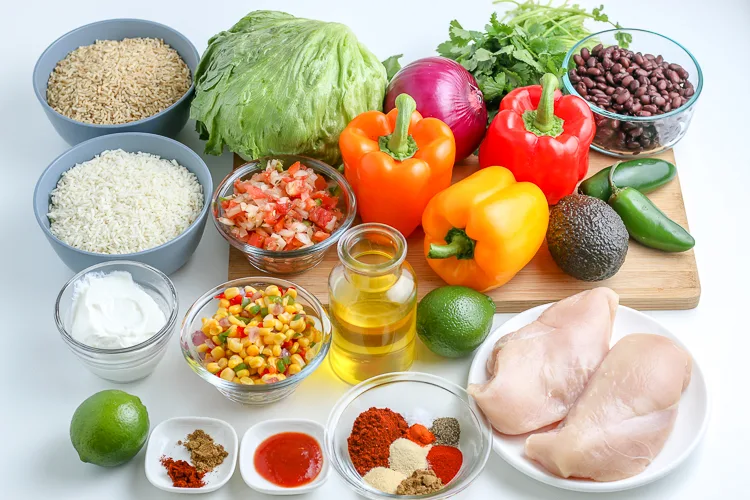 cutting board with chicken and fresh veggies