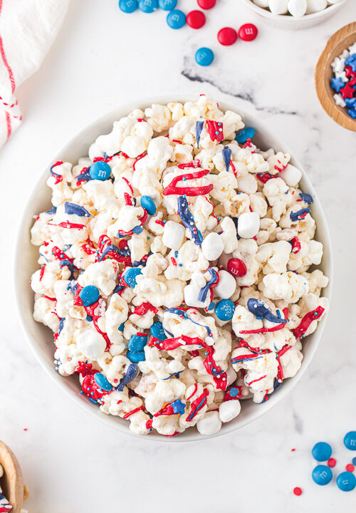 patriotic popcorn with red, white, and blue chocolate candies in a bowl