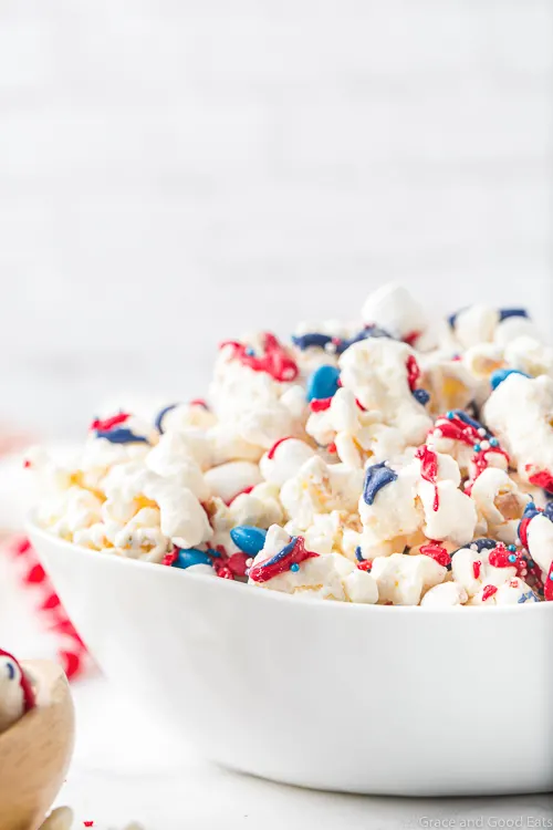white bowl with patriotic popcorn with a white brick background