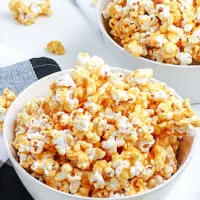 caramel corn in a white bowl